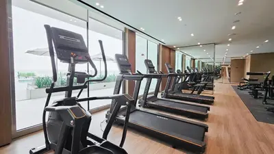a gym with a row of treadmills in a building at StayShort - Perfect Studio in Binghatti Azure JVC - Sleeps 2 in Dubai