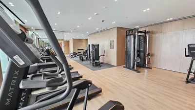 a gym with treadmills and ellipticals in a room at StayShort - Perfect Studio in Binghatti Azure JVC - Sleeps 2 in Dubai