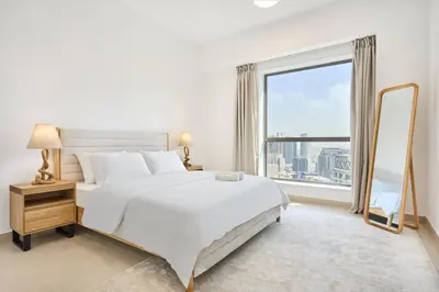 a bedroom with a large white bed and a large window at Modern 3BR in Rimal 5, JBR Dubai in Dubai