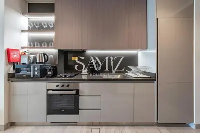 a kitchen with a counter with asaw sign on it at Chic Studio Unit 1808 Peninsula Five in Sabkhah
