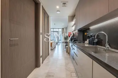a large kitchen with a sink and a counter at Chic Studio Unit 1808 Peninsula Five in Sabkhah
