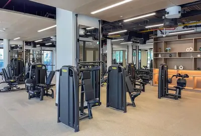 a gym with rows of exercise bikes and treadmills at Chic Studio Unit 1808 Peninsula Five in Sabkhah
