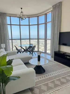 a living room with a white couch and a table at 1BR Amazing Dubai And Sea View in Dubai