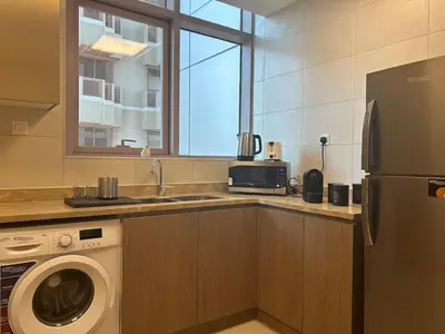 a kitchen with a washing machine and a window at 1BR Amazing Dubai And Sea View in Dubai