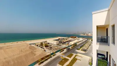 a view of the beach from a building at Locations l Upgraded 1 Bedroom l Sea Views, Beach Access l Port de La Mer in Dubai