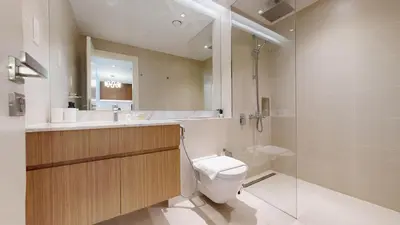 a bathroom with a toilet and a sink and a shower at Locations l Upgraded 1 Bedroom l Sea Views, Beach Access l Port de La Mer in Dubai