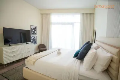 a bedroom with a large bed and a television at Urban Grandeur at Imperial Avenue in Dubai