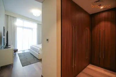 a room with a sliding door to a bedroom at Urban Grandeur at Imperial Avenue in Dubai