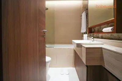 a bathroom with a sink and a toilet and a mirror at Urban Grandeur at Imperial Avenue in Dubai