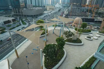 a view of a city with a playground with umbrellas at Urban Grandeur at Imperial Avenue in Dubai
