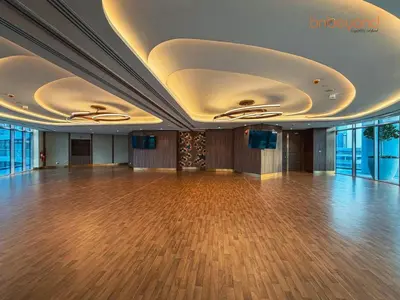 a large ballroom with a wooden floor and ceilings at Urban Grandeur at Imperial Avenue in Dubai