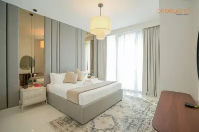 a bedroom with a bed and a large window at Private Beach Access with Luxury Beachfront Lifestyle in Dubai