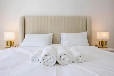 a bed with white towels on top of it at Modern Luxury Marina Stay with Ain Dubai View - Near JBR Beach in Dubai