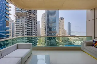 a balcony with a couch and a view of a city at Modern Luxury Marina Stay with Ain Dubai View - Near JBR Beach in Dubai