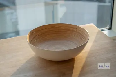 a bowl sitting on top of a wooden table at Waterfront 1BR Apartment At Heart of Dubai Marina in Dubai
