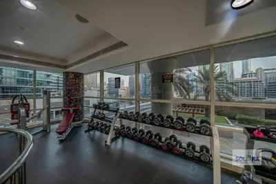 a gym with a view of a city at Waterfront 1BR Apartment At Heart of Dubai Marina in Dubai
