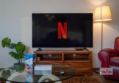a flat screen tv sitting on a wooden entertainment center at Waterfront 1BR Apartment At Heart of Dubai Marina in Dubai