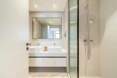 a bathroom with a sink and a shower at Modern 2BR Retreat with Stunning Sea Views in Dubai