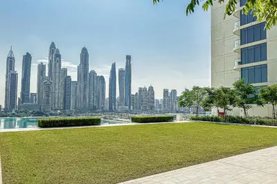 a park with a view of a city skyline at Modern 2BR Retreat with Stunning Sea Views in Dubai