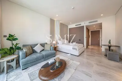 a living room with a couch and a bed at Cozy Studio - Unit 1807 - Peninsula Five in Dubai