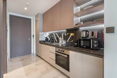 a kitchen with a counter top and a microwave at Cozy Studio - Unit 1807 - Peninsula Five in Dubai