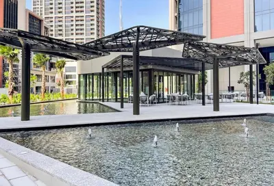 a pavilion with swans in a pond in a city at Sleek 1BR Gem - Unit 1709 - Peninsula Five in Dubai