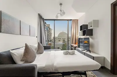 a bedroom with a large bed and a couch at FIRST CLASS 2BR Luxury Hideaway in Dubai