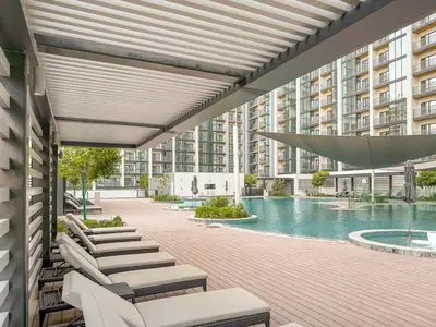 an outdoor patio with a pool and a building at FIRST CLASS 2BR Luxury Hideaway in Dubai