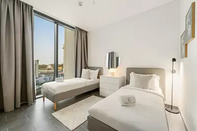 a hotel room with two beds and a large window at FIRST CLASS 2BR Luxury Hideaway in Dubai
