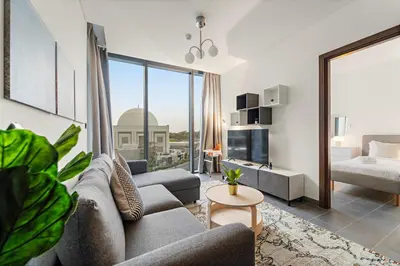 a living room with a couch and a large window at FIRST CLASS 2BR Luxury Hideaway in Dubai