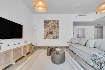 a living room with a couch and a tv at GYL Holiday Homes I Spacious 4 BDR Apt in JBR Beach, Dubai eye & Marina I Unbeatable location in Dubai