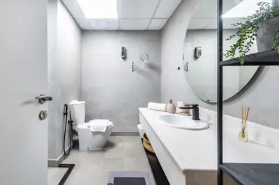 a bathroom with a sink and a toilet and a mirror at GYL Holiday Homes I Spacious 4 BDR Apt in JBR Beach, Dubai eye & Marina I Unbeatable location in Dubai