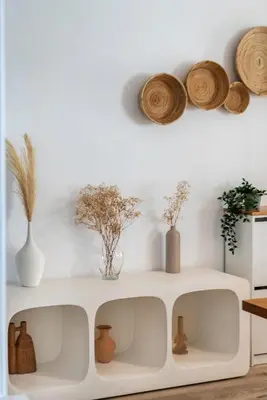 a white shelf with vases and plants on a wall at GYL Holiday Homes I Spacious 4 BDR Apt in JBR Beach, Dubai eye & Marina I Unbeatable location in Dubai