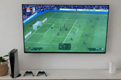 a tv hanging on a wall displaying a soccer game at GYL Holiday Homes I Spacious 4 BDR Apt in JBR Beach, Dubai eye & Marina I Unbeatable location in Dubai
