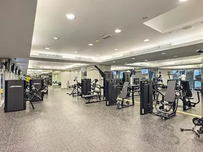 a gym with a lot of treadmills and exercise bikes at FIRST CLASS 1BR Downtown Luxury in Dubai