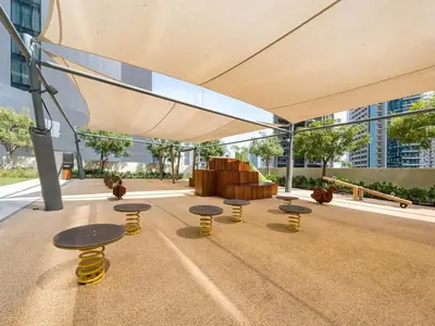 a group of tables and benches in a building at Stunning 2BR- Burj Royale 411 - Burj Khalifa View in Dubai