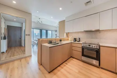 a kitchen with a sink and a stove top oven at Stunning 2BR- Burj Royale 411 - Burj Khalifa View in Dubai