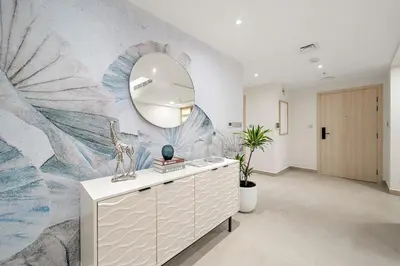 a room with a dresser with a mirror on a wall at FIRST CLASS 2BR Burj and Fountain Cozy Luxe in Dubai