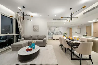 a living room with a couch and a table at FIRST CLASS 2BR Burj and Fountain Cozy Luxe in Dubai