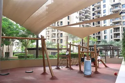 a playground in a city with a swing at Madinat Jumeirah Living in Dubai