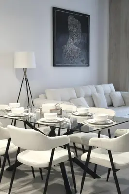 a dining room with a table and white chairs at Madinat Jumeirah Living in Dubai