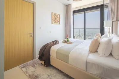 a bedroom with a large bed with a large window at Frank Porter - Aykon City 2 Tower C in Dubai