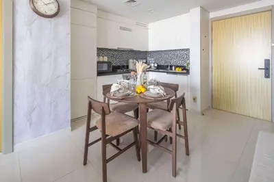a kitchen and dining room with a table and chairs at Frank Porter - Aykon City 2 Tower C in Dubai