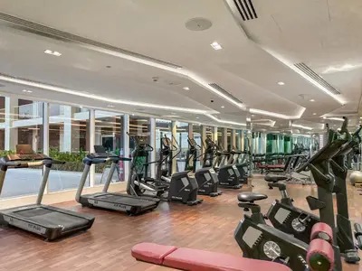 a gym with a lot of treadmills and ellipticals at FIRST CLASS Studio Chic and Comfy in Jewelz in Dubai