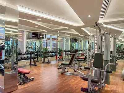 a gym with several treadmills and machines in a building at FIRST CLASS Studio Chic and Comfy in Jewelz in Dubai