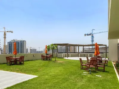 a group of tables and chairs with umbrellas on a patio at FIRST CLASS Studio Chic and Comfy in Jewelz in Dubai