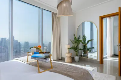 a bedroom with a bed and large windows at Maison Privee - City Heights Retreat with Panoramic Skyline Views in Dubai