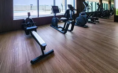 a gym with several treadmills and exercise bikes at FIRST CLASS 1BR Elegant Living with City Views in Dubai