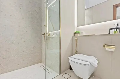 a bathroom with a toilet and a shower at FIRST CLASS 1BR Elegant Living with City Views in Dubai