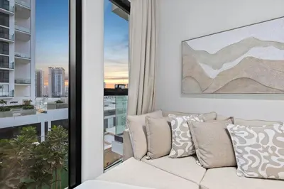 a living room with a couch in front of a window at FIRST CLASS 1BR Elegant Living with City Views in Dubai